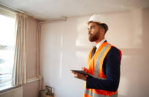 Surveyor at a home developing a Real Property Report.