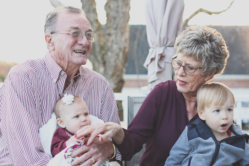Grandparents spending time with their grandchildren while they think about creating a will and estate planning