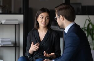 A woman meeting with a male lawyer for legal advice.