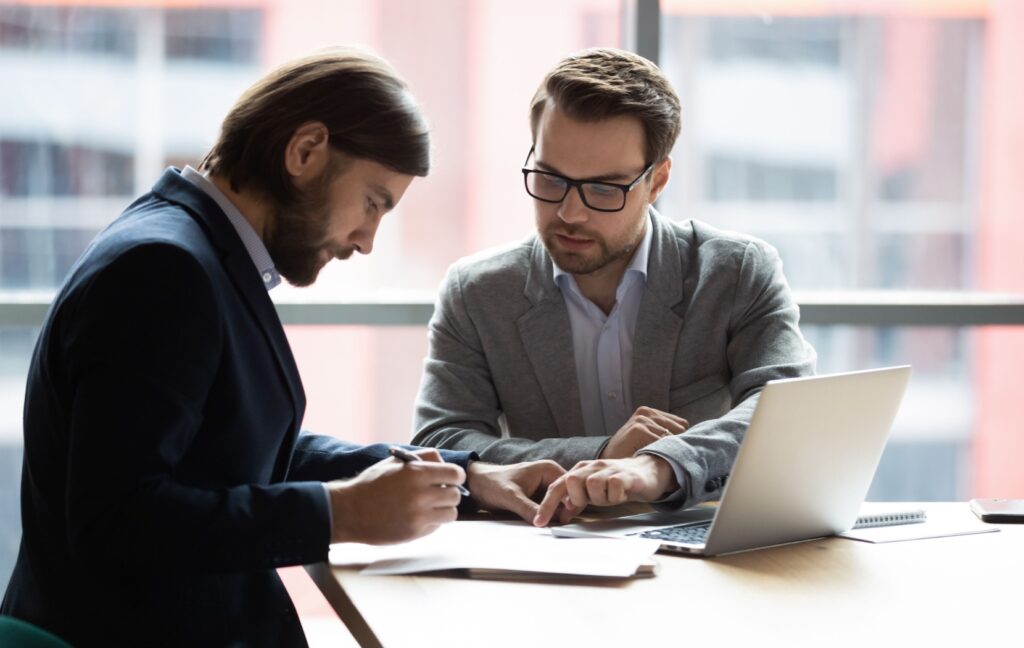 A franchisee signs their franchise agreement with their legal counsel after extensive review to make sure the agreement is clear, fair, and legally complaint.